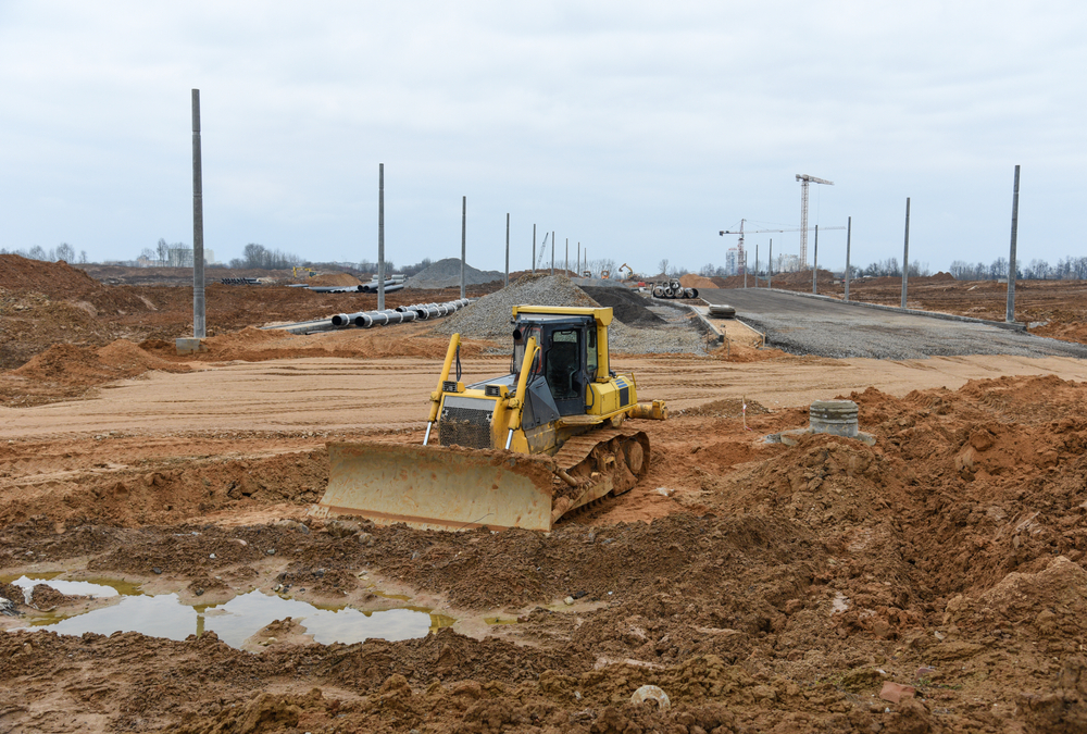 Bulldozer,moves,gravel,during,on,road,work,at,construction,site.