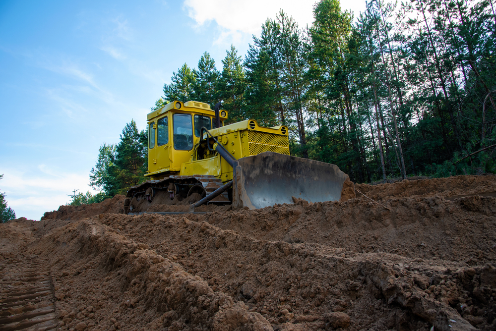Dozer,during,clearing,forest,for,construction,new,road,.,yellow
