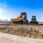 Track,bulldozer,,earth Moving,equipment,at,construction,site,with,bright,blue